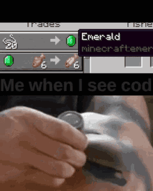 a person holding a watch next to a minecraft screen that says emerald