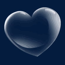 a clear glass heart on a dark background