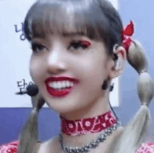 a close up of a woman wearing a choker and earrings .