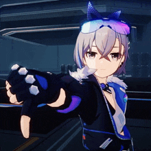 a girl with a cat ear hat and gloves is pointing at something