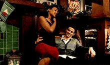 a man and a woman are sitting on a couch in a living room .