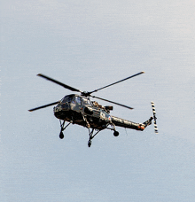 a black helicopter with the number 126 on the side of it