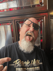 a man wearing sunglasses and a black shirt that says black hills harley-davidson