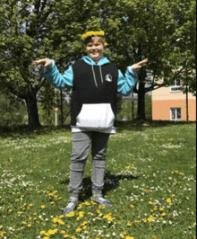 a young boy wearing a wreath of dandelions on his head is standing in a field of flowers .