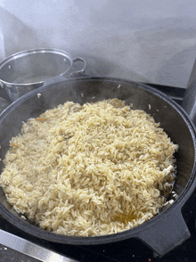 a pan of rice is cooking on a stove top