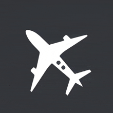 a white airplane is flying on a black background