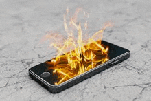 a cell phone with flames coming out of it 's screen .