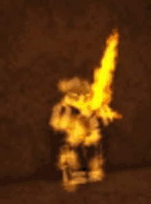 a blurred image of a person holding a sword with fire coming out of it .