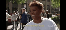 a woman is talking to a group of people on a street .