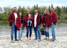 a group of people wearing plaid shirts are posing for a photo