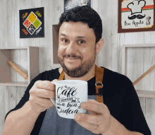 a man is holding a mug that says cafe