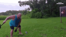 a man in a blue tank top is swinging a hammer in a field with the words awesome on the bottom right