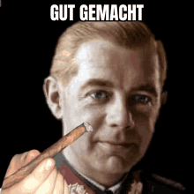 a man smoking a cigar with the words gut gemacht written above him