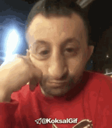 a man wearing a red shirt with the word koksal gif on it