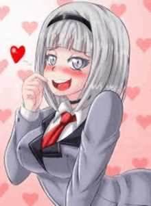 a girl in a suit and tie is smiling and holding a heart .