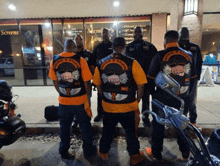 a group of men are standing in front of a store that says screens