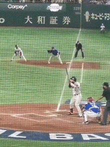 a baseball game is being played on a field with chinese writing on it