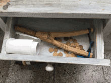 a wooden slingshot with austria written on it sits in a drawer