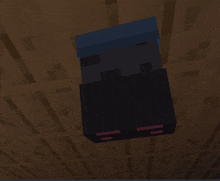 a black block with red eyes is hanging from a ceiling