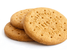 three digestive biscuits are stacked on top of each other on a white surface