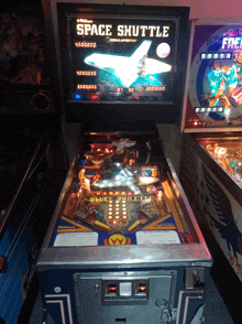 a pinball machine that says space shuttle on the top