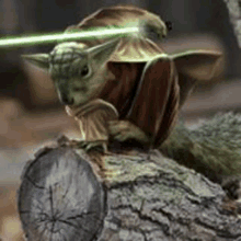 a baby yoda is sitting on a tree trunk with a green light coming out of his eyes .