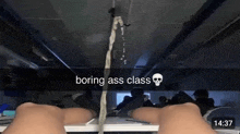 a person is sitting at a desk in a classroom with the words boring ass class written on the screen