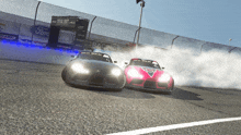 two cars are drifting on a race track with a ford advertisement in the background