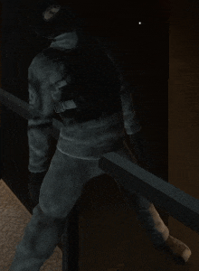 a man with a backpack is standing on a railing in a dark room