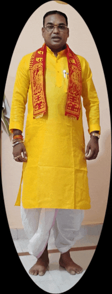 a man is wearing a yellow shirt and a red scarf around his neck that says ' shree ' on it