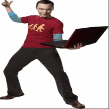 a man in a red shirt holds a red laptop