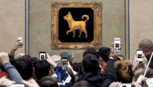 a crowd of people taking pictures of a picture of a dog on a wall