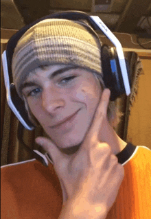 a young man wearing a beanie and headphones with the word evolve on the bottom