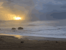 the sun is shining through the clouds over a beach