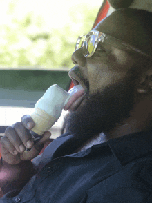 a man with a beard is eating an ice cream cone that says ice cream on it