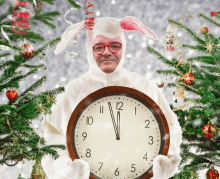 a man in a bunny costume is holding a clock