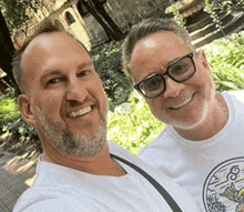 two men are posing for a picture together and smiling