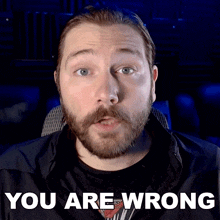 a man with a beard says " you are wrong " in front of him