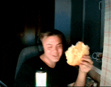 a man wearing headphones is holding a piece of bread in his hands