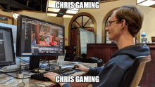 a man sitting at a desk playing a video game with the words chris gaming above him