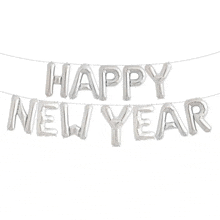 a string of silver foil balloons spelling out the words happy new year