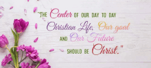 a sign that says " the center of our day to day christian life our goal and our future should be christ " with purple flowers