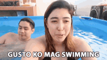 a man and a woman are swimming in a pool with gusto ko mag swimming written above them