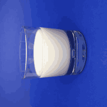 a glass of milk is on a blue background