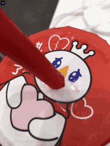 a snowman with a crown on his head is being poured into a red cup