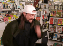 a man wearing a white hat is standing in front of a display of books including one called " clash "