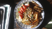 a plate of food with vegetables and french fries on a table