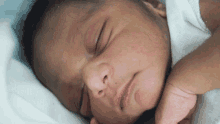 a close up of a baby 's face sleeping