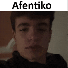 a close up of a man 's face with the words afentiko written above him .