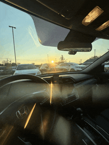 the sun shines through the windshield of a honda